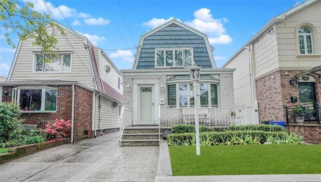 1413 81st St, Brooklyn, NY 11228 - dutch colonial with a gambrel roof, a front lawn, and brick siding