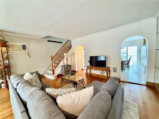 1413 81st St, Brooklyn, NY 11228 - living area with arched walkways, an AC wall unit, stairs, wood finished floors, and ornamental molding