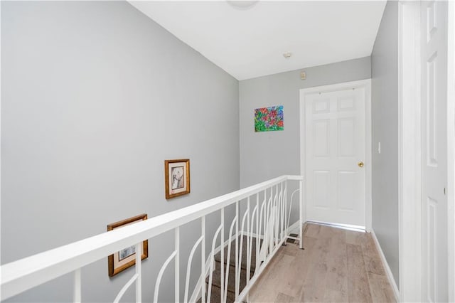131 Stonegate Dr Unit 1, Staten Island, NY 10304 - hall with light wood finished floors, baseboards, and an upstairs landing