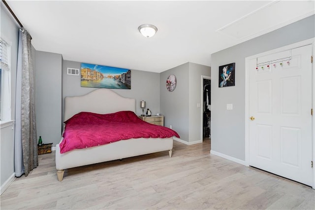 131 Stonegate Dr Unit 1, Staten Island, NY 10304 - bedroom with wood finished floors, attic access, and baseboards