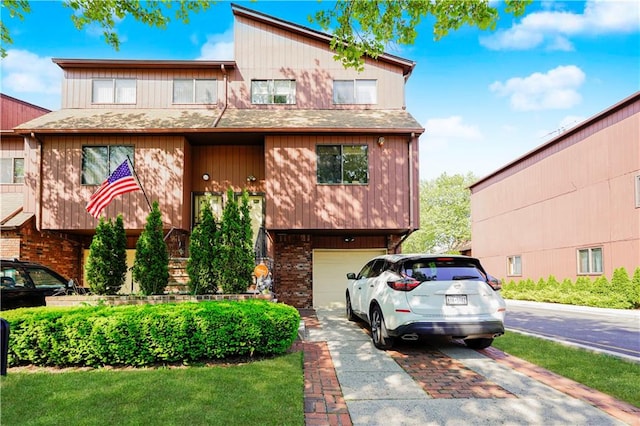 131 Stonegate Dr Unit 1, Staten Island, NY 10304 - view of front of house with an attached garage, driveway, and brick siding