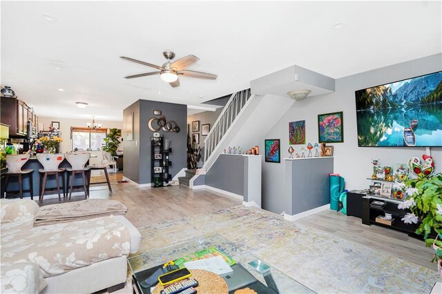 131 Stonegate Dr Unit 1, Staten Island, NY 10304 - living room featuring wood finished floors, a ceiling fan, stairs, and a chandelier