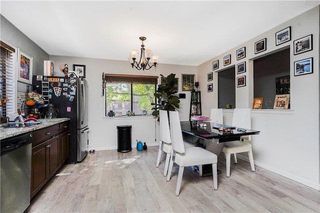 131 Stonegate Dr Unit 1, Staten Island, NY 10304 - dining area with a chandelier, light wood-style floors, and baseboards