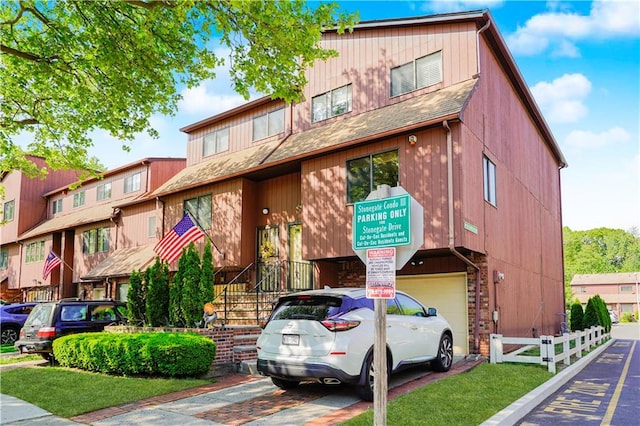 131 Stonegate Dr Unit 1, Staten Island, NY 10304 - view of property featuring a garage and driveway