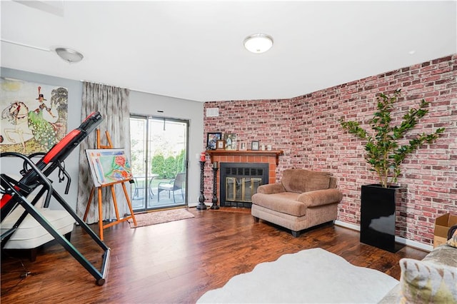 131 Stonegate Dr Unit 1, Staten Island, NY 10304 - living area featuring a brick fireplace, brick wall, and wood finished floors