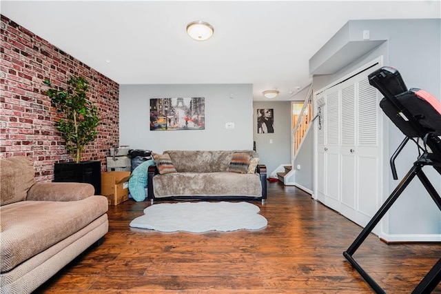 131 Stonegate Dr Unit 1, Staten Island, NY 10304 - living area featuring wood finished floors, stairway, and brick wall