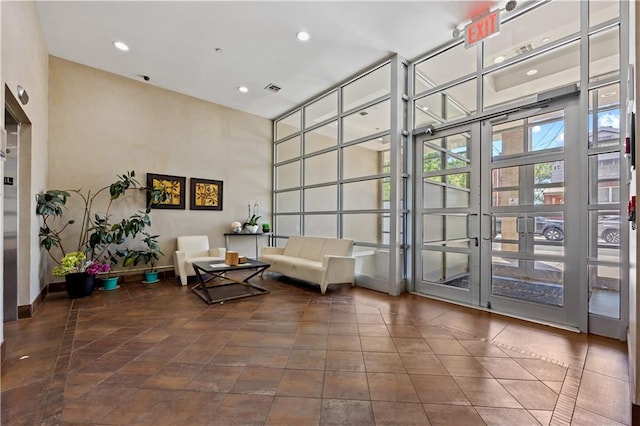 common area featuring recessed lighting and a towering ceiling
