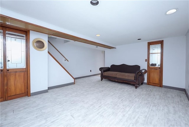 living area with light wood-type flooring, baseboards, stairs, and recessed lighting