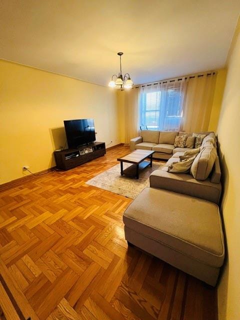 1900 Quentin Rd Unit F4, Brooklyn, NY 11229 - living room with a chandelier and baseboards