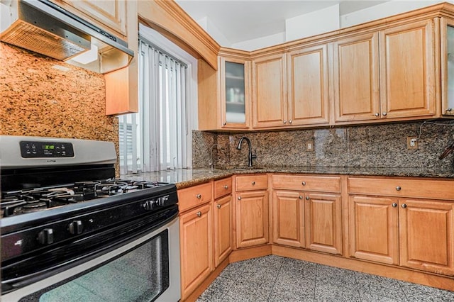 1519 71st St, Brooklyn, NY 11228 - kitchen with gas stove, range hood, granite floors, dark stone countertops, and tasteful backsplash