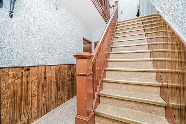 1519 71st St, Brooklyn, NY 11228 - stairway featuring wooden walls, wainscoting, and a textured wall