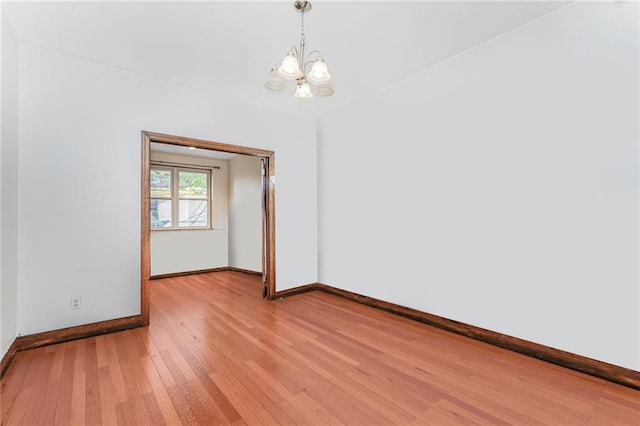 1519 71st St, Brooklyn, NY 11228 - spare room with a chandelier, baseboards, and light wood-style floors