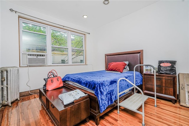 1519 71st St, Brooklyn, NY 11228 - bedroom featuring radiator, cooling unit, wood finished floors, and recessed lighting