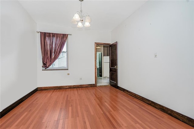 1519 71st St, Brooklyn, NY 11228 - empty room featuring a chandelier, baseboards, and light wood finished floors
