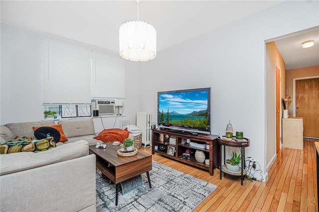 1519 71st St, Brooklyn, NY 11228 - living area with radiator, light wood-type flooring, cooling unit, and a chandelier