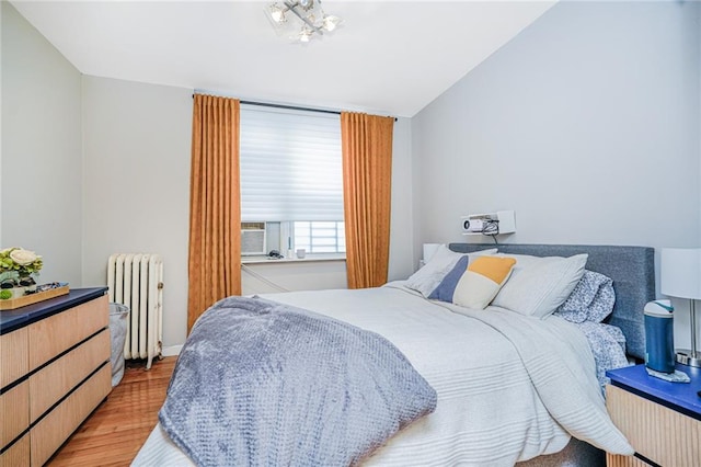 1519 71st St, Brooklyn, NY 11228 - bedroom featuring radiator heating unit, light wood-style flooring, and vaulted ceiling