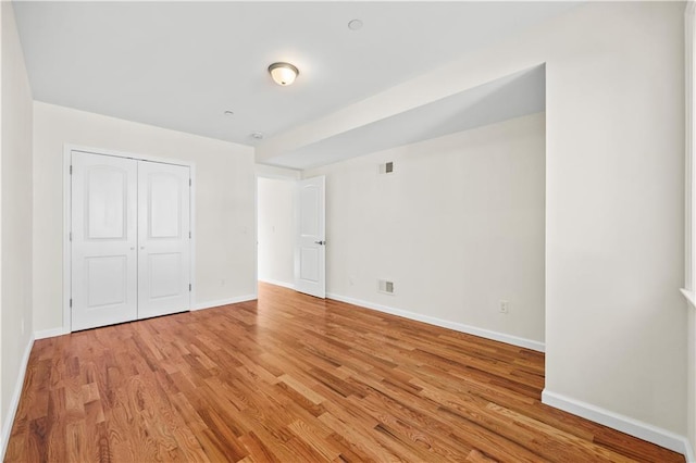 91 Robin Rd, Staten Island, NY 10305 - unfurnished bedroom with light wood finished floors, baseboards, and a closet
