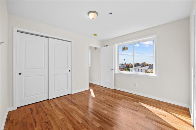 91 Robin Rd, Staten Island, NY 10305 - unfurnished bedroom with baseboards, wood finished floors, and a closet