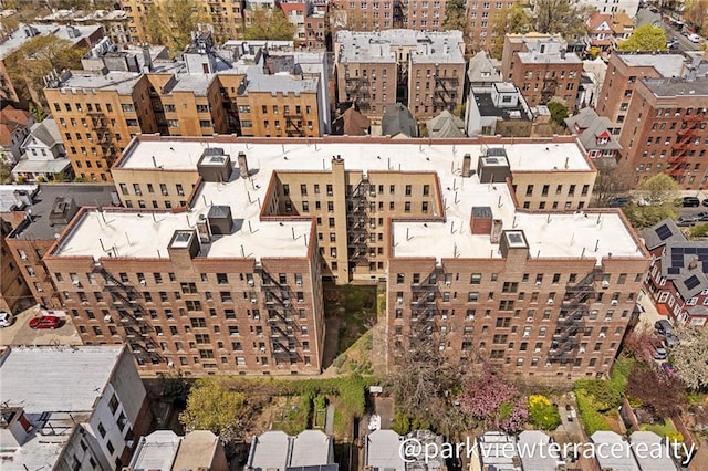 aerial view of property and surrounding area with nearby urban area