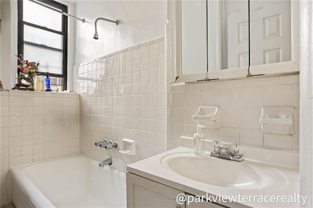 full bath featuring tile walls and vanity