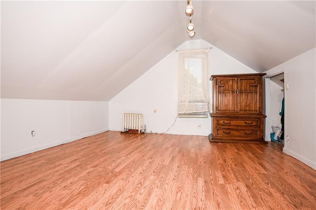 2064 Coleman St, Brooklyn, NY 11234 - additional living space with radiator heating unit, light wood finished floors, vaulted ceiling, and baseboards