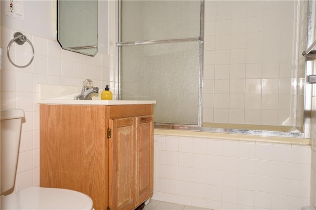 2064 Coleman St, Brooklyn, NY 11234 - bathroom featuring tile walls, toilet, tiled shower, and vanity