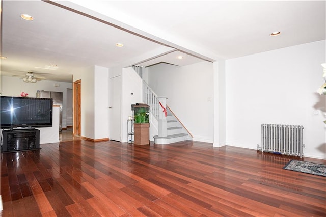 2064 Coleman St, Brooklyn, NY 11234 - unfurnished living room featuring radiator, wood finished floors, stairway, ceiling fan, and baseboards