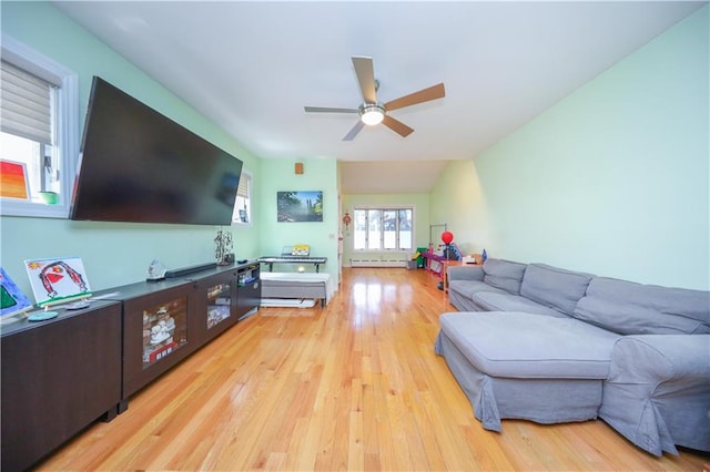 living area with ceiling fan, light wood-style flooring, and a baseboard radiator
