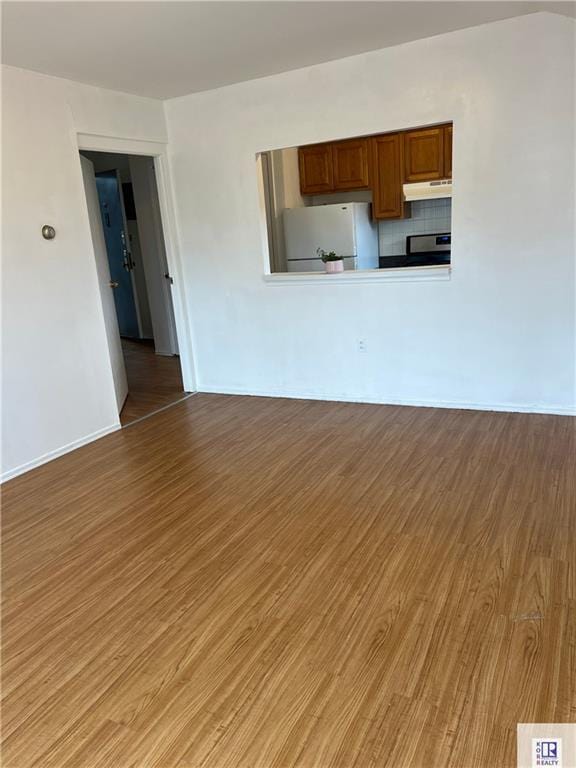 unfurnished living room featuring light wood-style flooring and baseboards