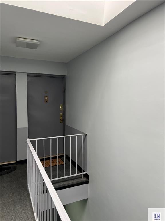 staircase featuring carpet floors