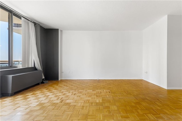 unfurnished room featuring baseboards