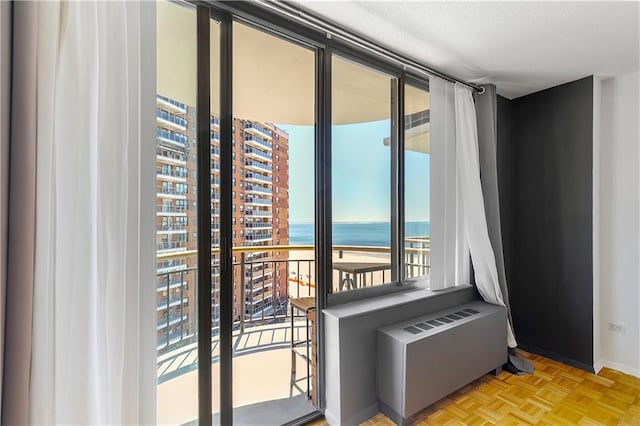 entryway with radiator heating unit and a water view