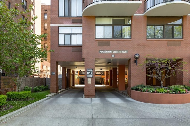 view of building exterior featuring a carport and driveway
