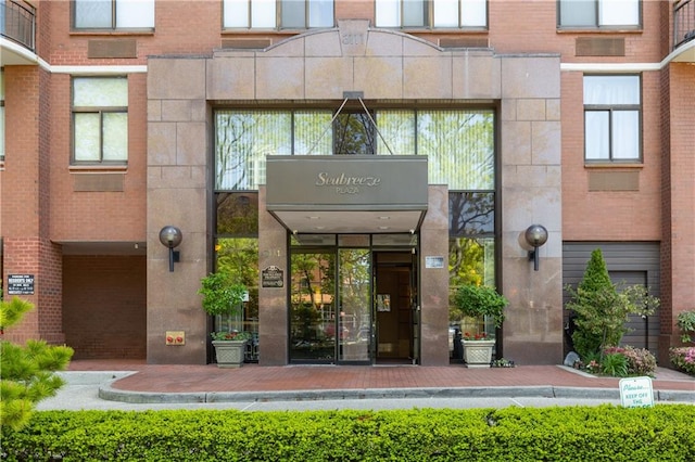 entrance to property featuring brick siding