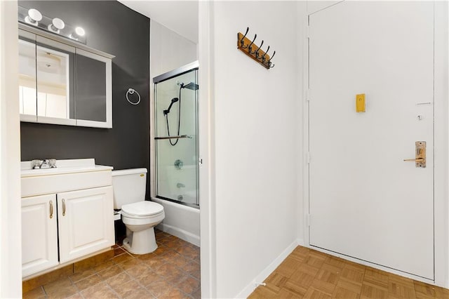 full bathroom with shower / bath combination with glass door, vanity, toilet, and baseboards