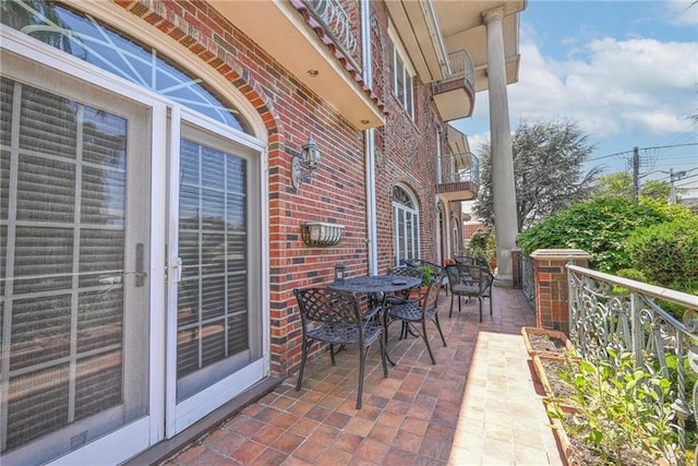 1401 74th St, Brooklyn, NY 11228 - view of patio featuring a balcony and outdoor dining area