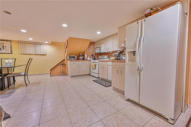 1401 74th St, Brooklyn, NY 11228 - kitchen with white appliances, recessed lighting, white cabinets, light tile patterned floors, and tile countertops