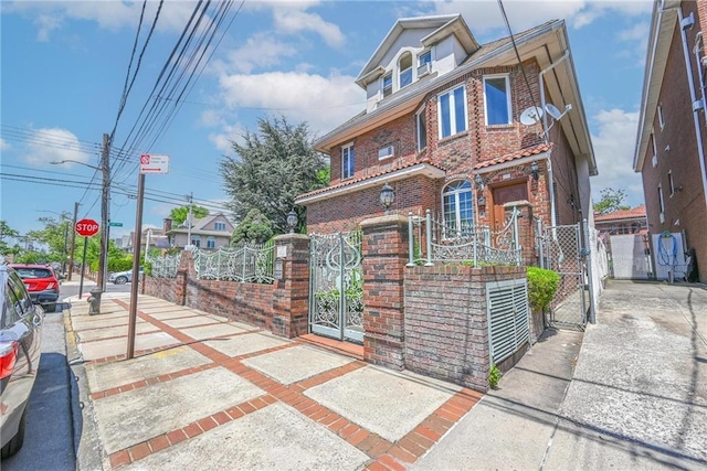 1401 74th St, Brooklyn, NY 11228 - view of front facade with a gate, brick siding, and a fenced front yard