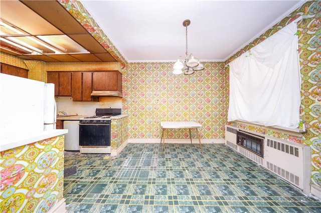 2327 E 16th St, Brooklyn, NY 11229 - kitchen featuring white appliances, wallpapered walls, radiator, under cabinet range hood, and a chandelier