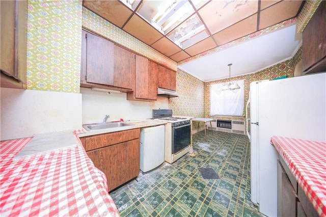 2327 E 16th St, Brooklyn, NY 11229 - kitchen featuring white appliances, wallpapered walls, a sink, light countertops, and under cabinet range hood