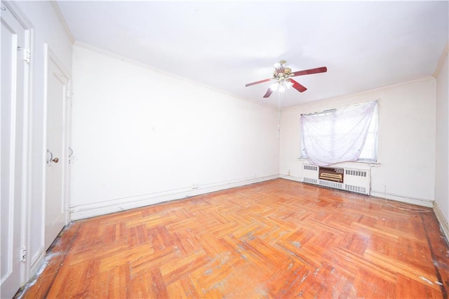 2327 E 16th St, Brooklyn, NY 11229 - unfurnished room featuring radiator, a ceiling fan, baseboards, and crown molding