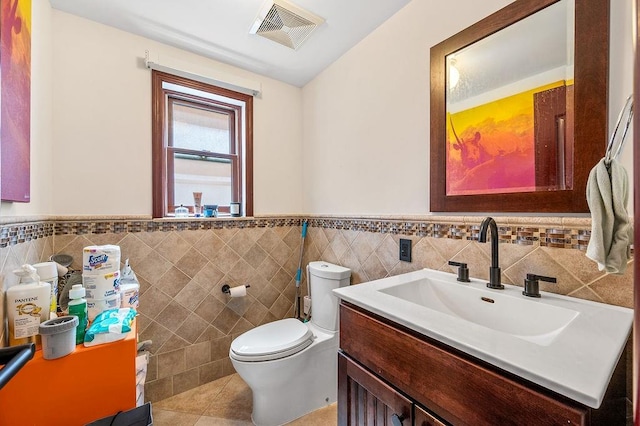 1440 81st St, Brooklyn, NY 11228 - bathroom with tile walls, a wainscoted wall, toilet, tile patterned flooring, and vanity