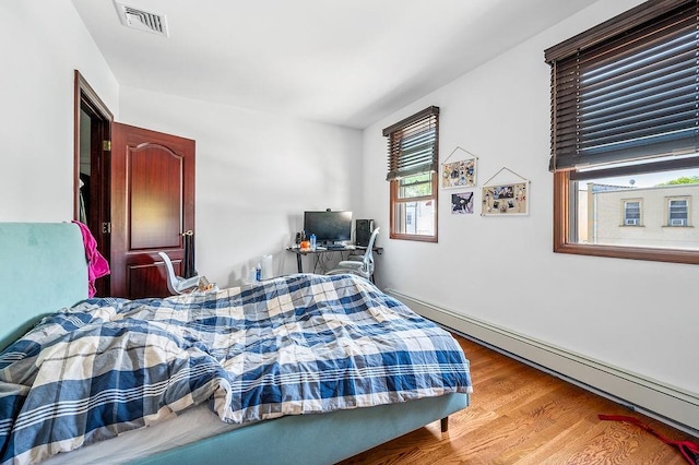1440 81st St, Brooklyn, NY 11228 - bedroom with wood finished floors and a baseboard heating unit