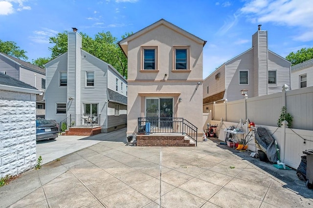 1440 81st St, Brooklyn, NY 11228 - back of property featuring fence, stucco siding, and a patio