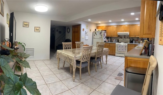 dining area featuring light tile patterned floors and recessed lighting
