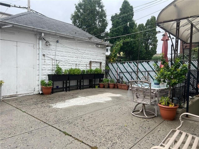 view of patio / terrace featuring fence