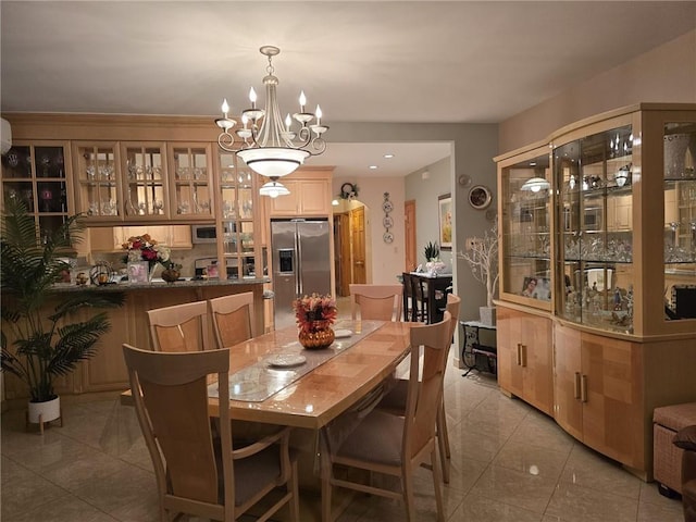 dining space featuring light tile patterned floors and a chandelier