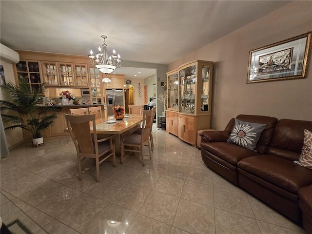 dining space with a chandelier and tile patterned flooring