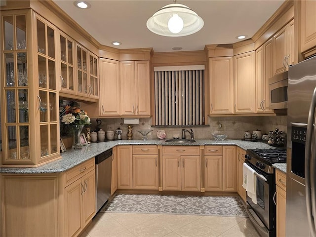 kitchen with appliances with stainless steel finishes, a sink, light brown cabinets, light stone counters, and recessed lighting