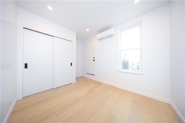 1238 77th St, Brooklyn, NY 11228 - unfurnished bedroom featuring a wall mounted AC, light wood-type flooring, recessed lighting, and a closet